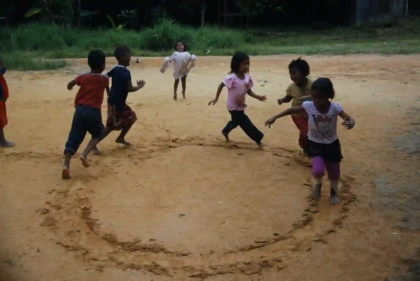 Children play a game in the open space of their village in Kelantan